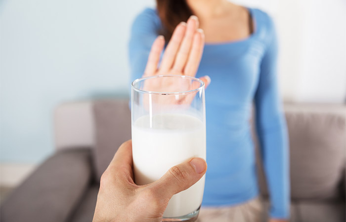 Woman saying no to dairy product to prevent comedonal acne