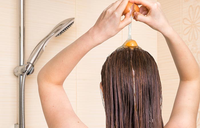 Woman applying egg to her hair