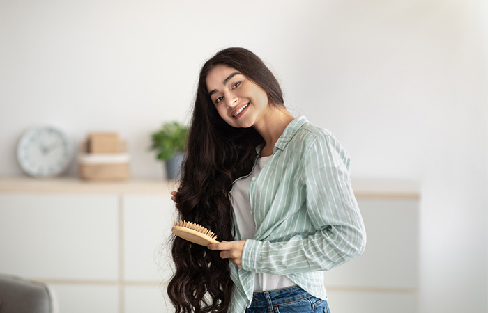 Woman brushing her healthy hair after using vegan hair dye